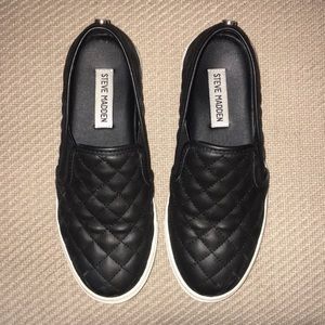 Steve Madden slip on black sneakers.